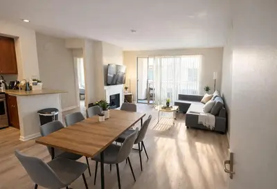 a living room with a table and chairs and a kitchen at Marina Del Rey Luxe 2-Bedroom & 1-Bedroom - Hot Tub, Pool Table, Grill & Cinema Projector in Marina del Rey