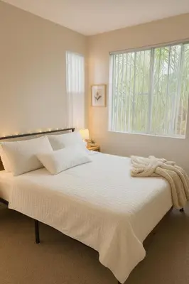 a bedroom with a large white bed with a window at Chic Marina 1 Bedroom - Pool - Hot Tub - Gym - Sauna in Los Angeles