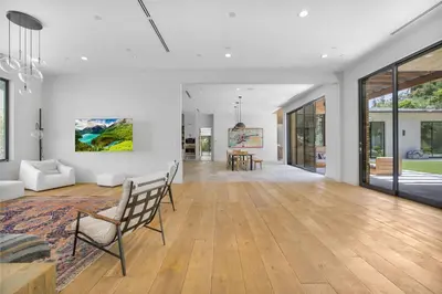 an open living room with white walls and wooden floors at Bowmont in Los Angeles