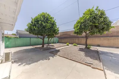 two trees in a driveway in front of a building at Cozy & Brand New 3BR Home in West Covina in West Covina