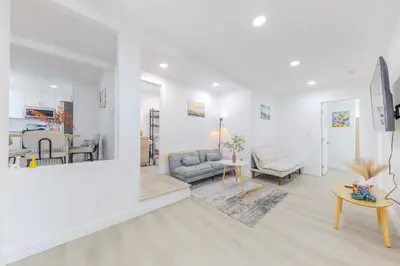 a white living room with a couch and a table at Cozy & Brand New 3BR Home in West Covina in West Covina