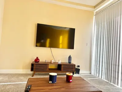 a living room with a tv and a coffee table at Cozy and Stylish Unit CC 107 in Los Angeles