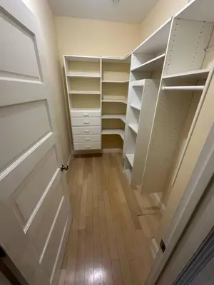 a walk in closet with white shelves and a door at Private room private balcony shared bathroom - Mini Mansion in Burbank