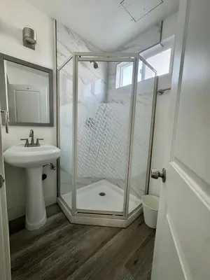 a bathroom with a shower and a sink at The Ostel in Los Angeles