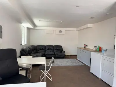 a living room with a couch and a table at The Ostel in Los Angeles
