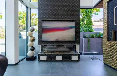 a flat screen tv sitting on a stand in a room at Venice House w Pool Spa Home Theater Rooftop in Los Angeles