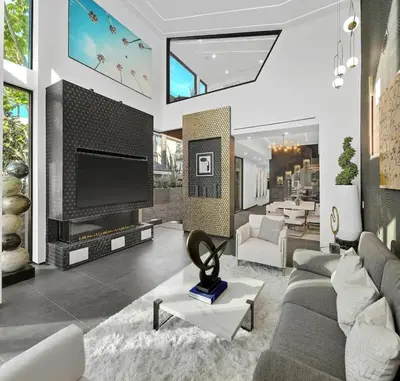 a living room with a large television and a living room with a couch at Venice House w Pool Spa Home Theater Rooftop in Los Angeles