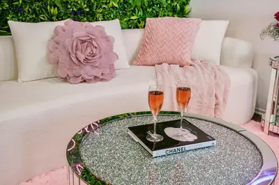 a coffee table with two glasses of wine on it at Luxury Pool View Spa Suite-Massage Chair-Steam Sauna-Welcome Champagne ! in Westlake Village