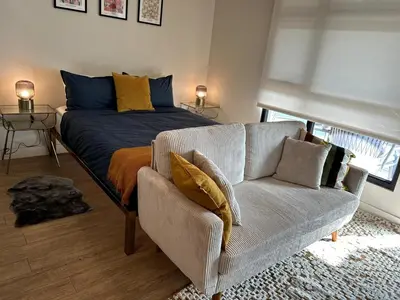 a living room with a couch and a bed at Cozy studio in heart of Santa Monica free parking in Los Angeles