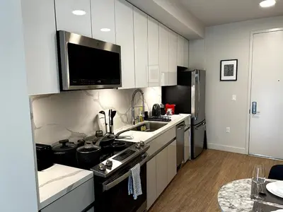 a kitchen with a sink and a microwave at Cozy studio in heart of Santa Monica free parking in Los Angeles