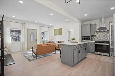 a large kitchen and living room with a couch at Stylish Cozy getaway in West Valley Area Heliport