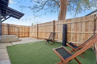 a backyard with two chairs and a fence at Stylish Cozy getaway in West Valley Area Heliport