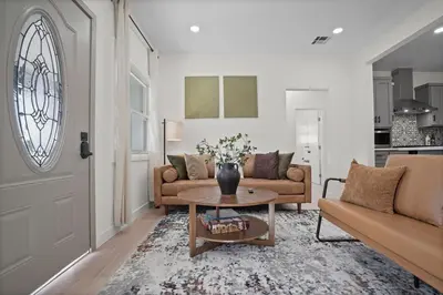a living room with a couch and a table at Stylish Cozy getaway in West Valley Area Heliport