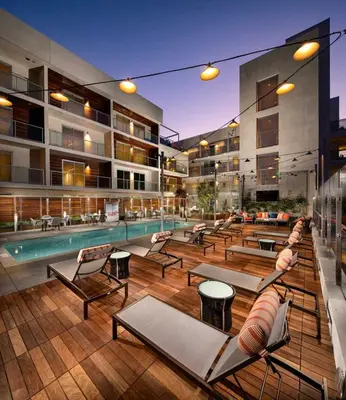 a swimming pool with lounge chairs and a building at Luxury by the Beach with Pool, Gym, Game Room in Los Angeles