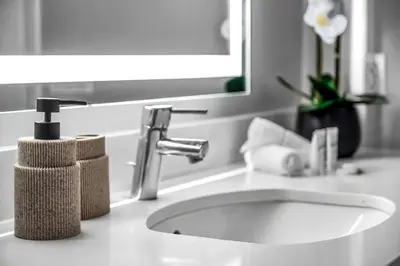 a white bathroom sink with a faucet and a mirror at Luxury by the Beach with Pool, Gym, Game Room in Los Angeles