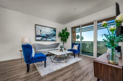 a living room with blue chairs and a couch at Luxury by the Beach with Pool, Gym, Game Room in Los Angeles