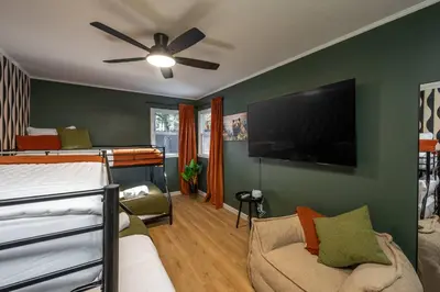 a bedroom with a bed and a flat screen tv at Summit Haven: Game Room | Sauna | Spa | 1/4 Acre in Big Bear Lake