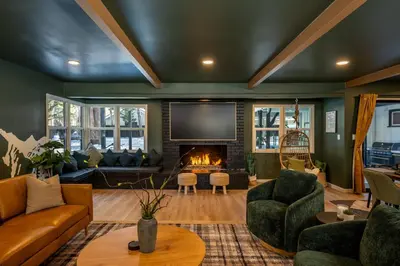 a living room with a couch and a fireplace at Summit Haven: Game Room | Sauna | Spa | 1/4 Acre in Big Bear Lake
