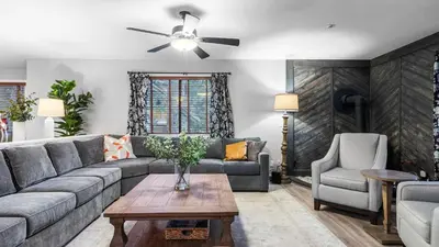 a living room with a couch and a table at 5BDR Stay w Fireplace Game room Family-Friendly Amenities Arrowhead Chalet by AvantStay in Lake Arrowhead