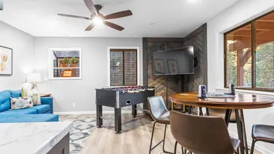 a living room with a ping pong table and a television at 5BDR Stay w Fireplace Game room Family-Friendly Amenities Arrowhead Chalet by AvantStay in Lake Arrowhead