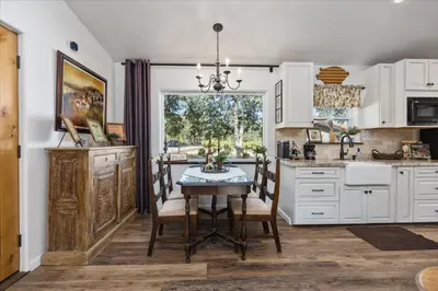a kitchen with a table and chairs and a window at The Petite-Villas at Dorner Family Vineyard in Tehachapi