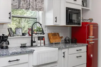 a kitchen with a sink and a red refrigerator at The Petite-Villas at Dorner Family Vineyard in Tehachapi
