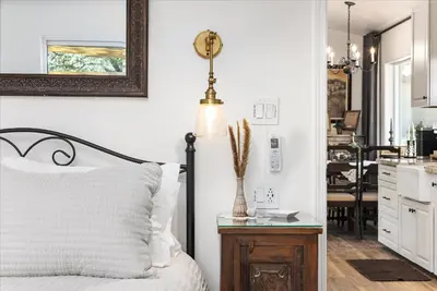 a bedroom with a bed and a table with a lamp at The Petite-Villas at Dorner Family Vineyard in Tehachapi