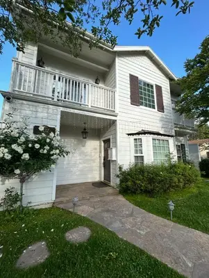a white house with a balcony and a yard at Private room in guest house - Mini Mansion in Burbank