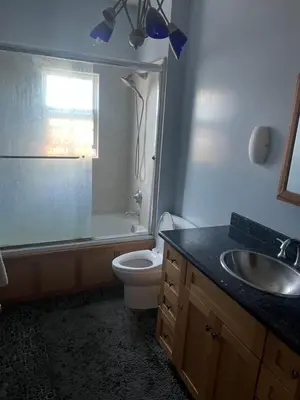 a bathroom with a toilet and a sink and a shower at Private room in guest house - Mini Mansion in Burbank