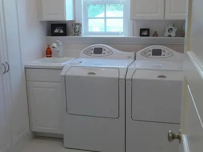 a white kitchen with white washer and dryer at Private room in guest house - Mini Mansion in Burbank