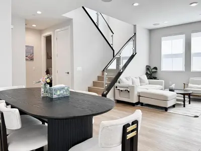 a living room with a black table and chairs at #Marbella Lane - Spacious 4BR Modern Family Home! in Placentia