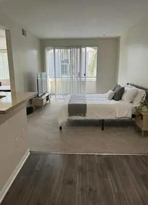 a large bedroom with a bed and a kitchen at Beachside Marina Del Rey 2BR & 1BR - Resort Amenities in Los Angeles