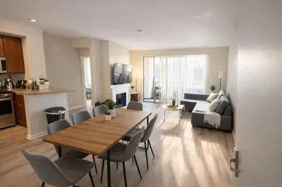 a living room with a table and chairs and a kitchen at Beachside Marina Del Rey 2BR & 1BR - Resort Amenities in Los Angeles