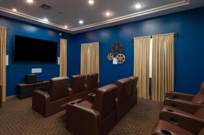 a blue room with chairs and a flat screen tv at Marina Del Rey Beach Retreat w Hot Tub, Billiards & Grill in Los Angeles
