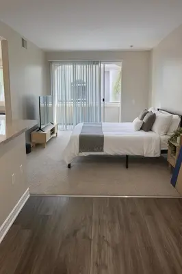 a bedroom with a large bed and a large window at Marina Del Rey Beach Retreat w Hot Tub, Billiards & Grill in Los Angeles