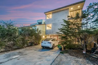 a white van parked in front of a house at ocean front beach house in Oxnard