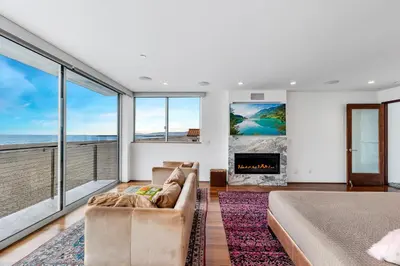 a living room with a couch and a fireplace at ocean front beach house in Oxnard