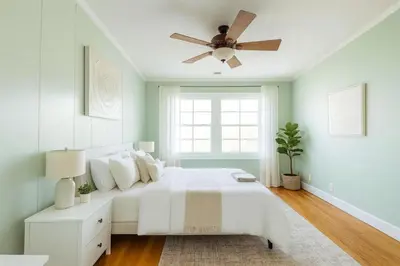 a bedroom with a white bed and a ceiling fan at Fullerton Family-Ready- 9 min to Disneyland in Fullerton