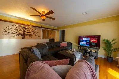 a living room with a couch and a flat screen tv at Fullerton Family-Ready- 9 min to Disneyland in Fullerton
