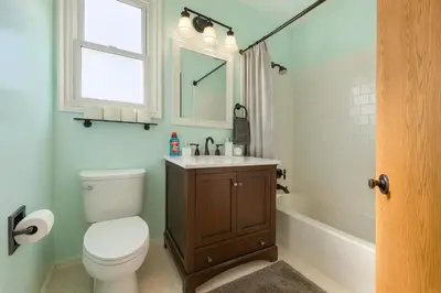 a bathroom with a toilet and a sink and a mirror at 4BR Fullerton Retreat - Private Backyard in Fullerton
