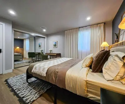 a bedroom with a large bed and a living room at Dondo Stay in Los Angeles