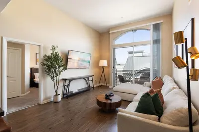 a living room with a couch and a table at Serene Zen Peaceful Zen Garden View with Pool Gym in Los Angeles
