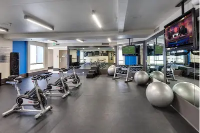 a gym with several exercise bikes and a flat screen tv at Serene Zen Peaceful Zen Garden View with Pool Gym in Los Angeles