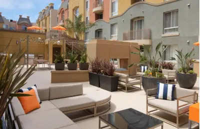 a patio with furniture and plants on a building at Serene Zen Peaceful Zen Garden View with Pool Gym in Los Angeles