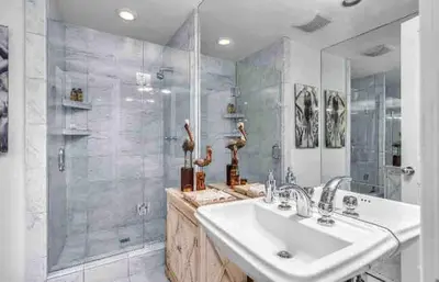 a bathroom with a sink and a shower at Oceanfront, Pool, Jacuzzi NO HWY Noise! in Malibu Beach