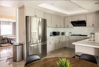 a kitchen with a stainless steel refrigerator and a table at CA1 Fun And Central Home with Sauna in La Palma