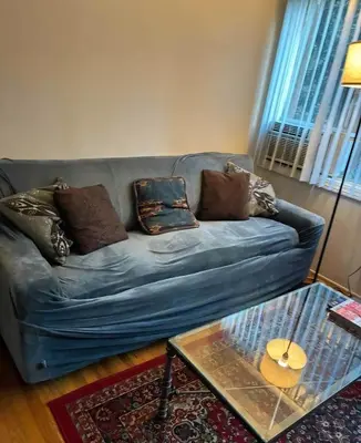 a living room with a blue couch with pillows at Beautiful apartment close to Cedars! Beverly Hills in Los Angeles