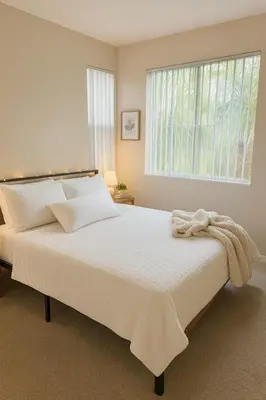 a white bedroom with a large bed with a window at Marina Del Rey Getaway - Resort Amenities in Marina del Rey in Los Angeles