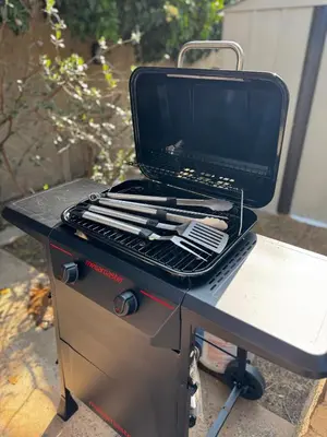 a grill with a laptop sitting on top of it at The Maze House Pool Theatre Room in San Bernardino