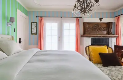 a bedroom with a large white bed and a chandelier at Luxe Homestay in Hollywood - by The Grove & Walk of Fame in Los Angeles
